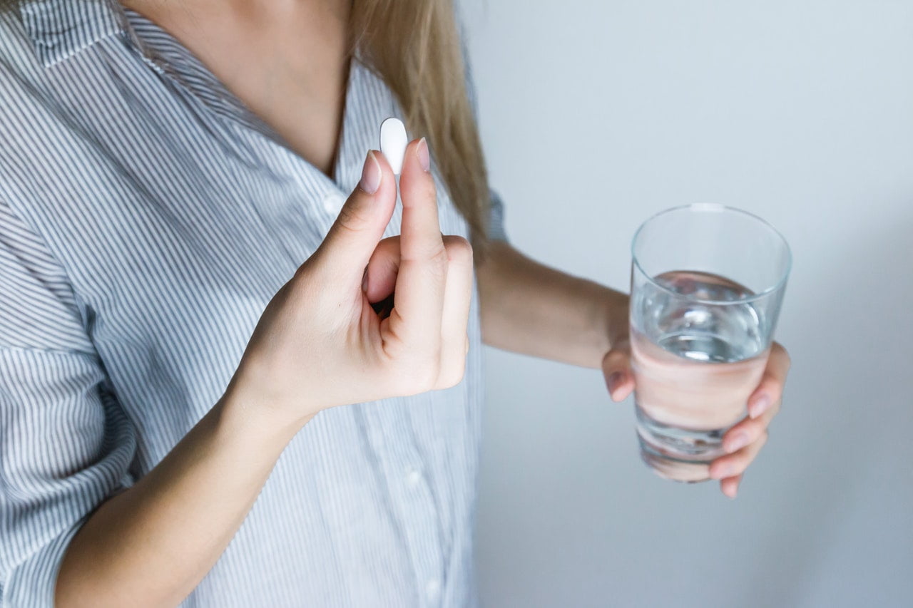 a person holding a glass of water