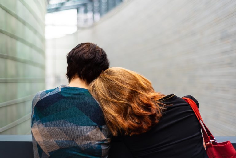 a couple people looking at a wall