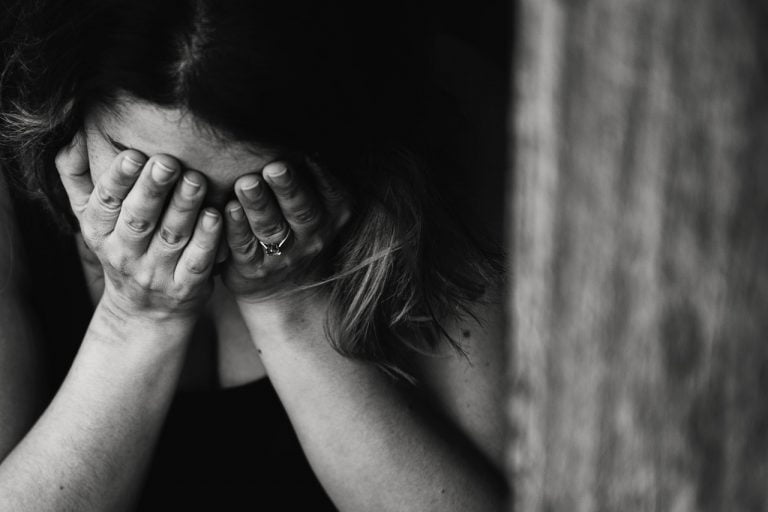a person holding the face