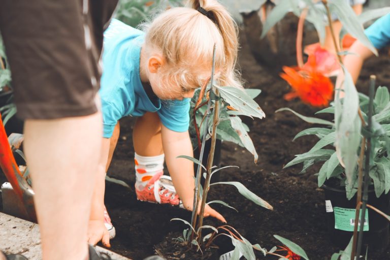 a young girl looking at plants