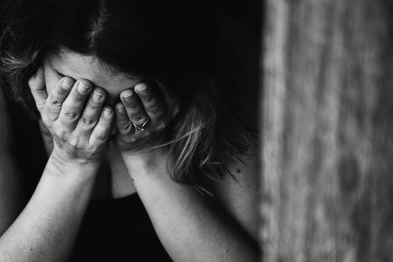 a person holding the face