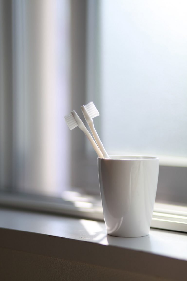 a cup with a toothbrush in it
