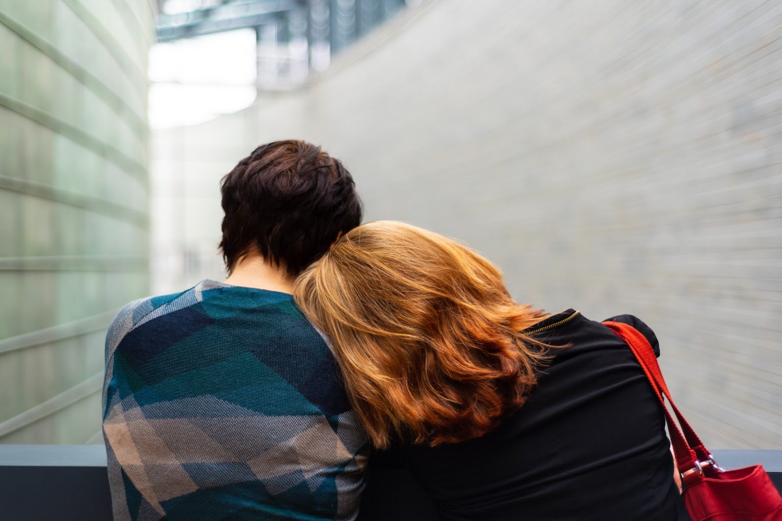 a couple people looking at a wall